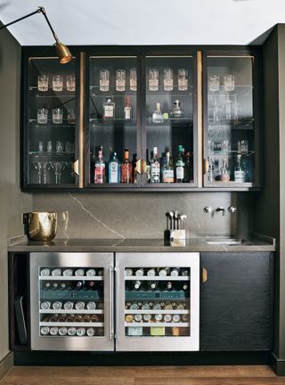Home bar with dark wood cabinets