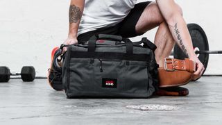 Person packing his gym gear into a gym bag