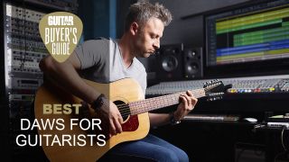 Man plays an acoustic guitar in his studio