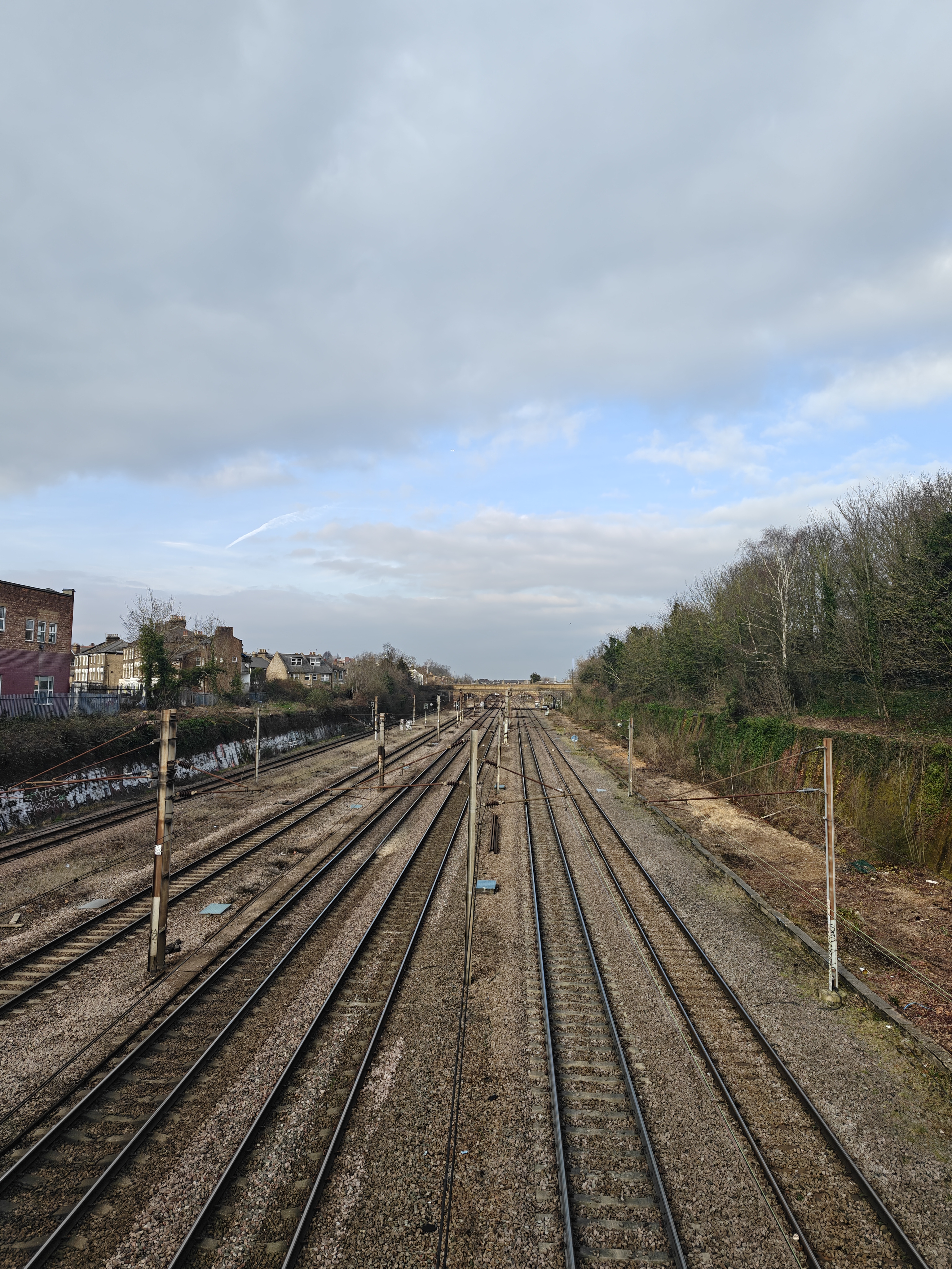 A railway track leading up to a stone bridge