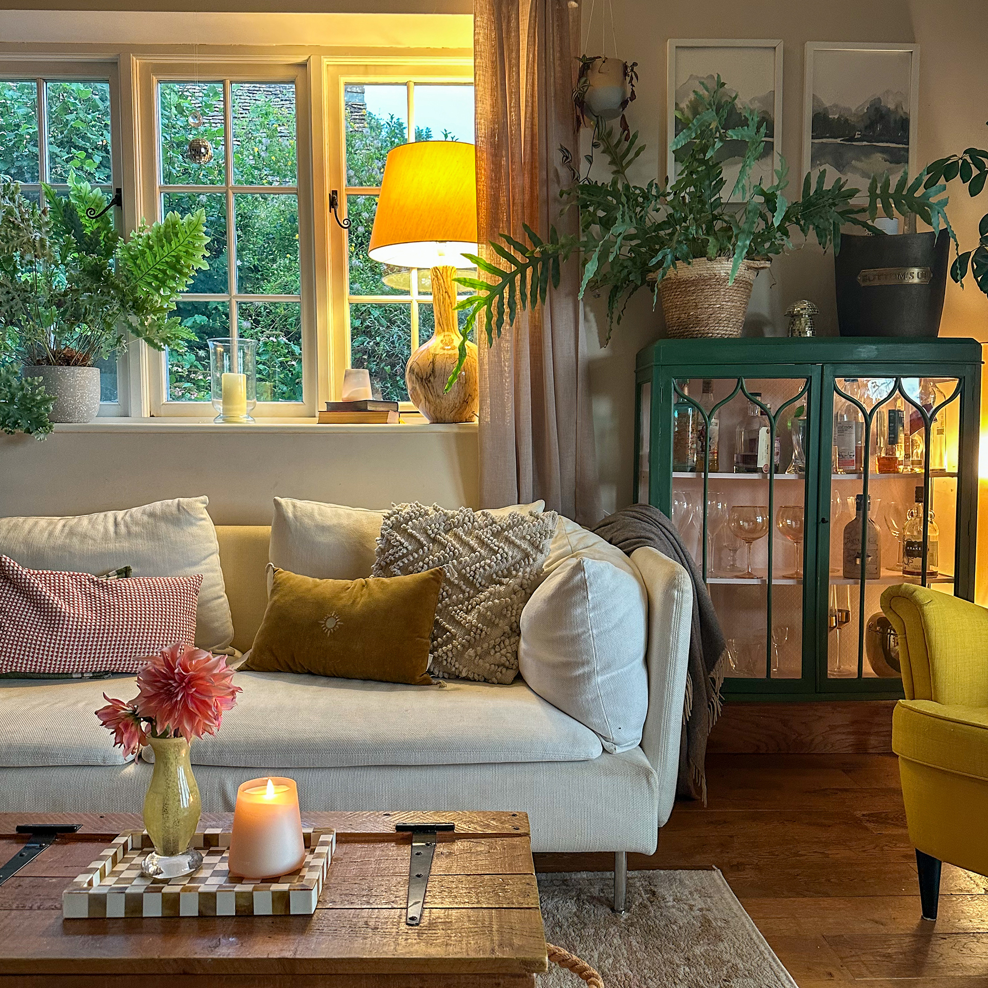country living room lit by a warm yellow table lamp