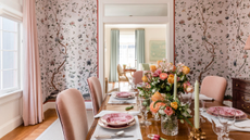 Pink dining room with flowers and candles