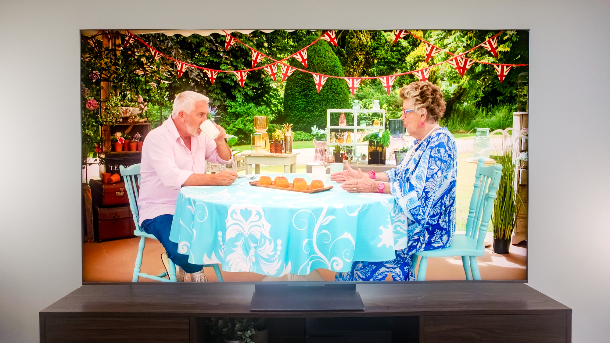 A TCL QM9K TV on a side table