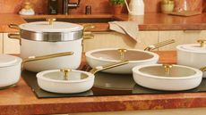 Our Place Essentials Cookware Set in Cream in a terracotta kitchen