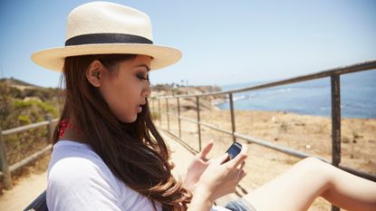 Hat, Human leg, Leisure, Summer, People in nature, Wrist, T-shirt, Sitting, Headgear, Sun hat, 