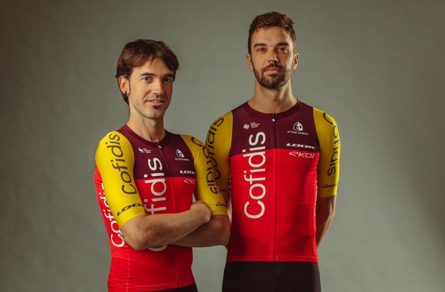 Two Cofidis riders in their new 2025 kit, with red body and yellow arms