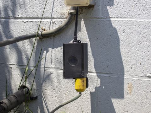 Ring Outdoor Smart Plug Hanging From Outlet