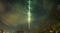 A long exposure photo showing the fireball's green light streaking across the sky