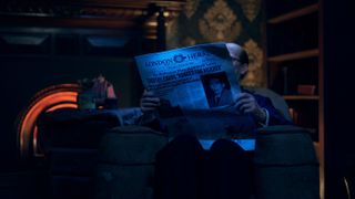 Man reading a newspaper in the Chamber of Horrors