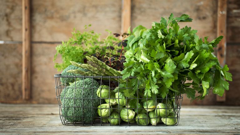 A basket filled with green vegetables