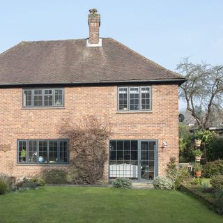 house with brick wall and garden area