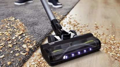 Beko cordless vacuum cleaner in use on a dirty floor