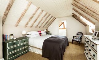 bedroom with vaulted ceiling and faux rafters