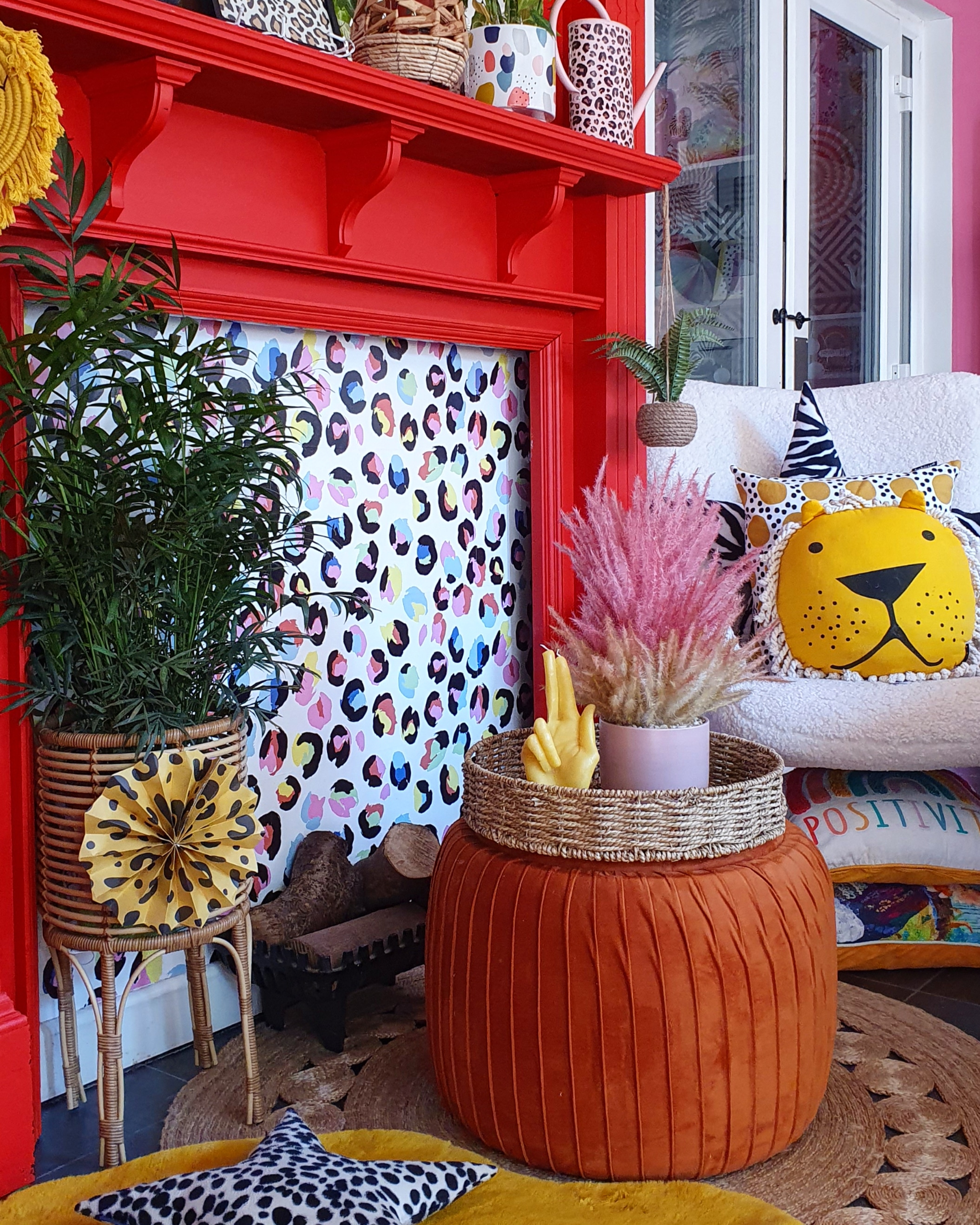 red painted fireplace with leopard print wallpaper