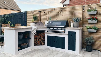 blue outdoor kitchen with bar stools