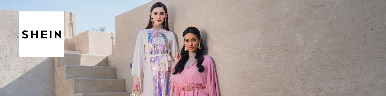 Shein logo placed over a wide image of two ladys posing with stone wall behind them 