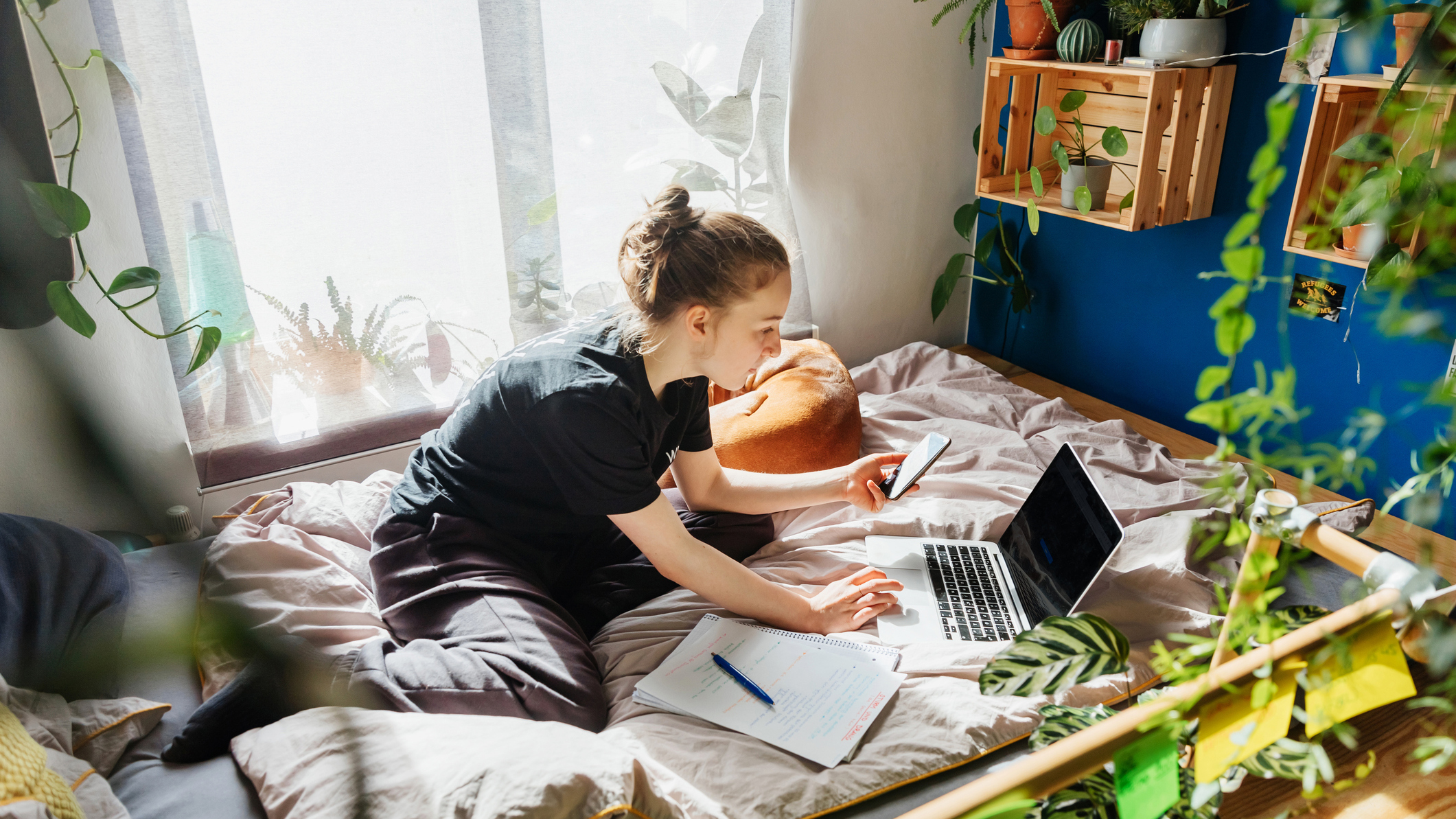 Student using a laptop on a dormitory bed