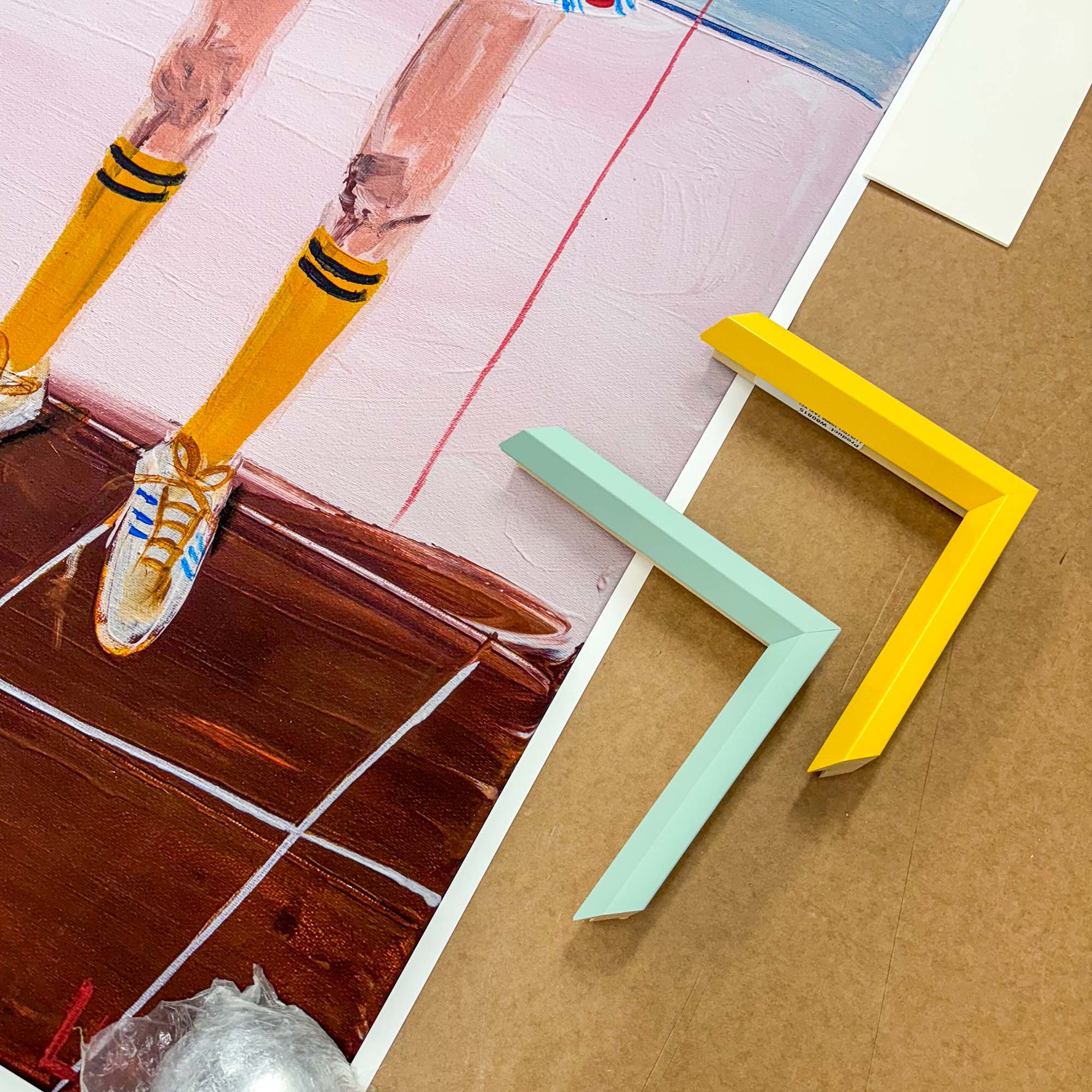 colourful pieces of frame next to the corner of an art print