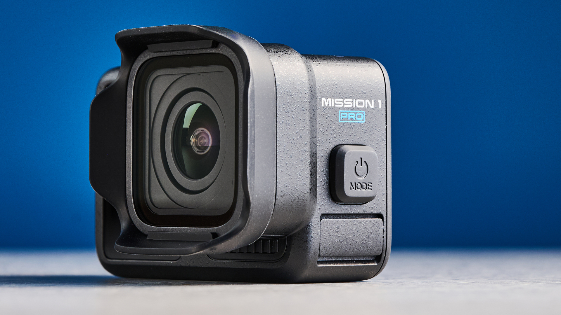 The GoPro Mission 1 Pro side profile against a blue background