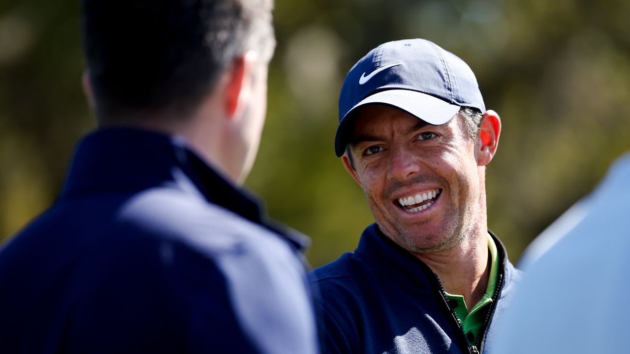 Rory McIlroy smiles while having a conversation