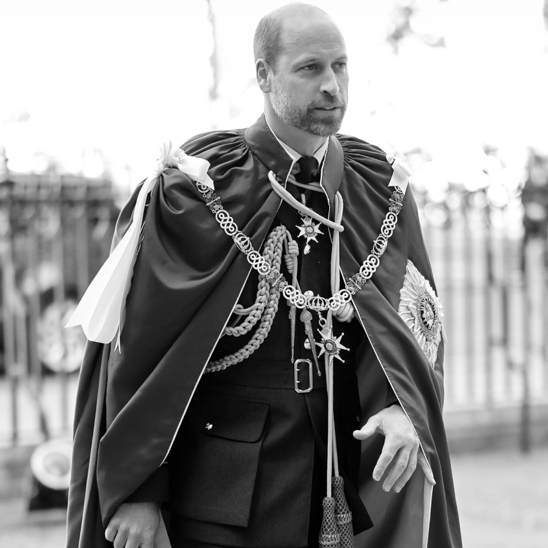 A black and white picture of Prince William wearing a robe with medals 