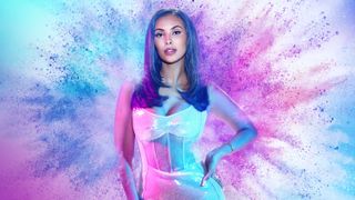 Glow Up: Britain's Next Make Up Star - A stylised picture of presenter Maya Jama standing in front of an explosion of coloured powder