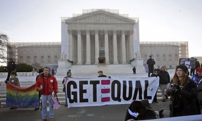 Demonstrators stand outside the Supreme Court on March 26. 