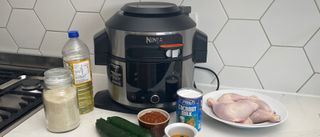 The Ninja Foodi 11-in-1 SmartLid multi-cooker with ingredient ready to cook a chicken curry