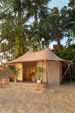 Aman's new mobile cabana in a beach setting with a Thai-inspired roof