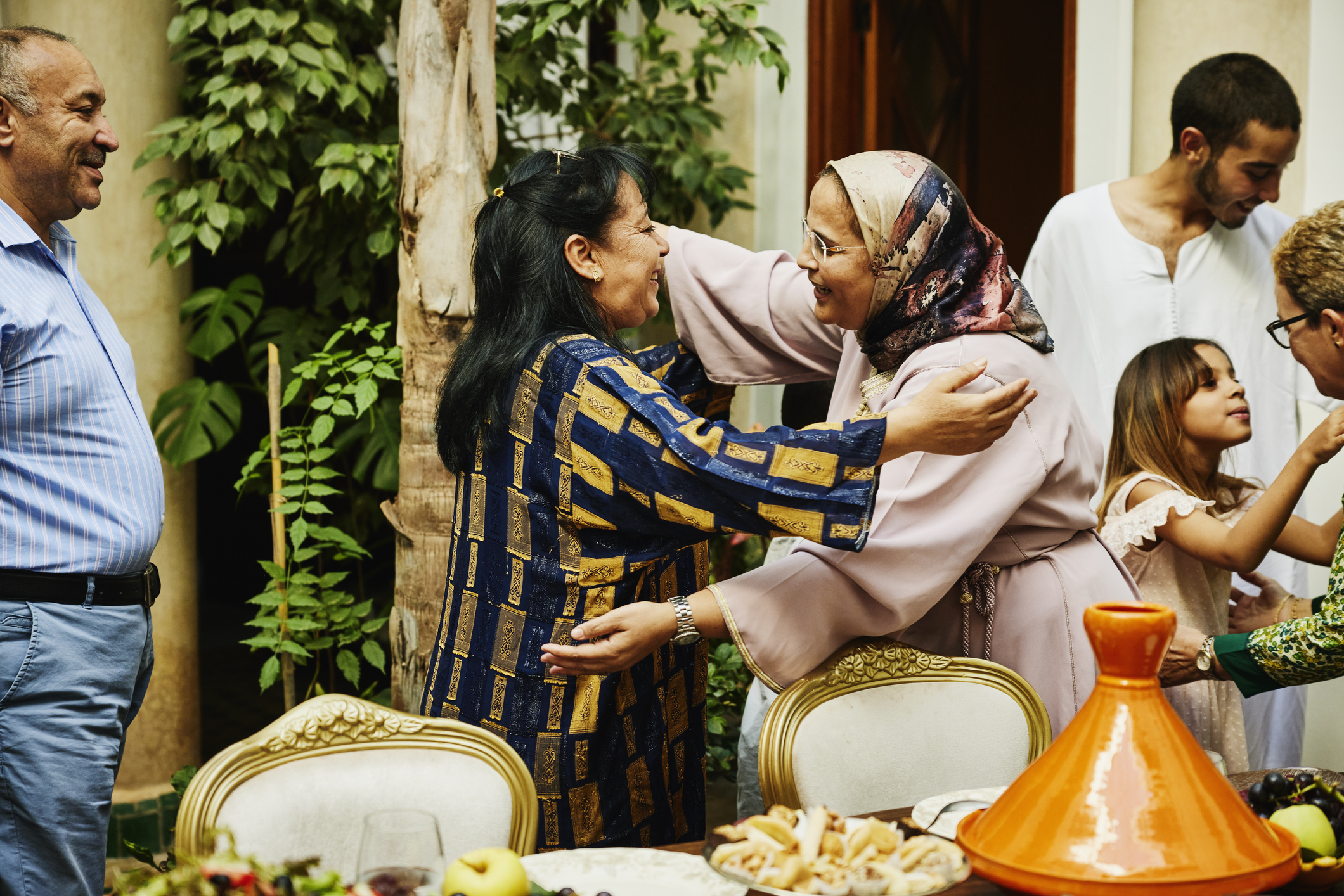 A Muslim family hugging and celebrating Eid together.