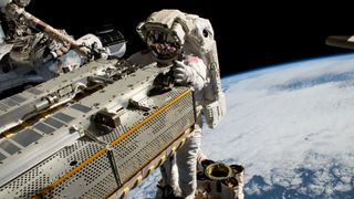 NASA astronaut and Expedition 68 Flight Engineer Woody Hoburg riding the Canadarm2 robotic arm while maneuvering a roll-out solar array toward the International Space Station’s truss structure 257 miles above the Pacific Ocean