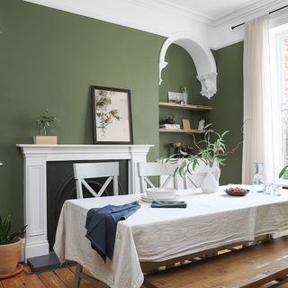 green dining room with table and cloth