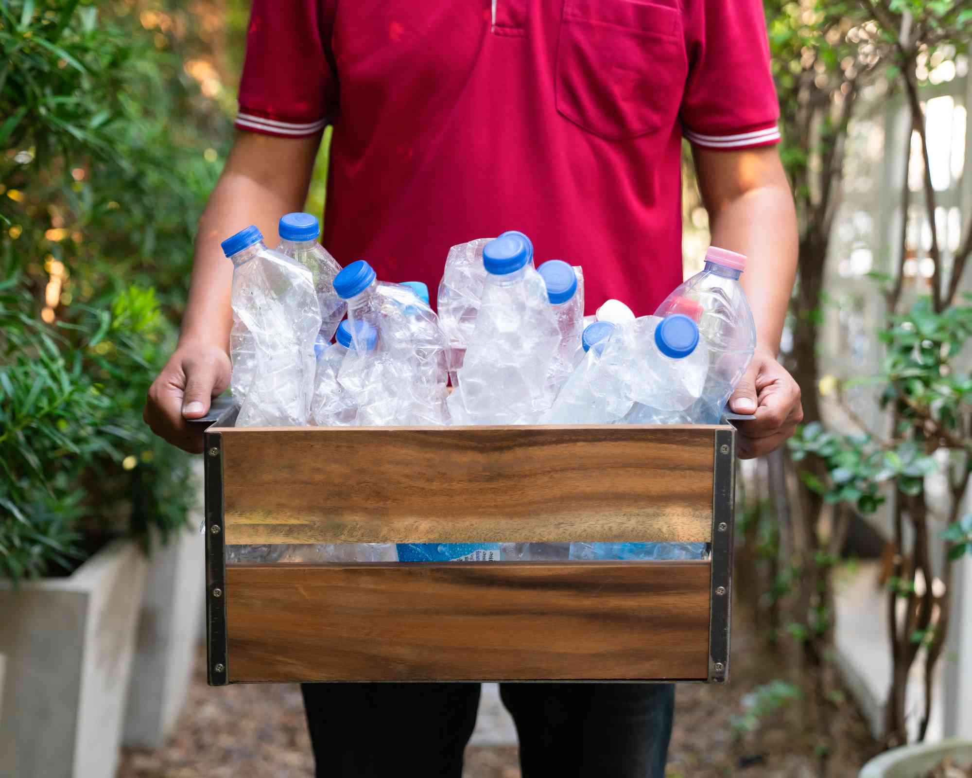 Man with plastic bottles for recycling