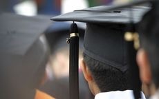 College graduates wearing caps with tassels, seen from behind.