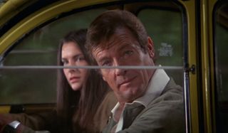Roger Moore driving a Citroen with Carole Bouquet during a getaway in For Your Eyes Only.