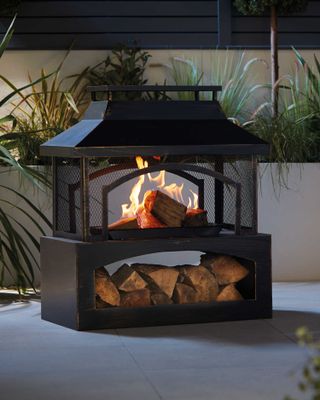 Gardenline outdoor log burner, lit outdoors