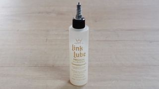 A bottle of Peaty’s Link Lube Premium All Weather lube 