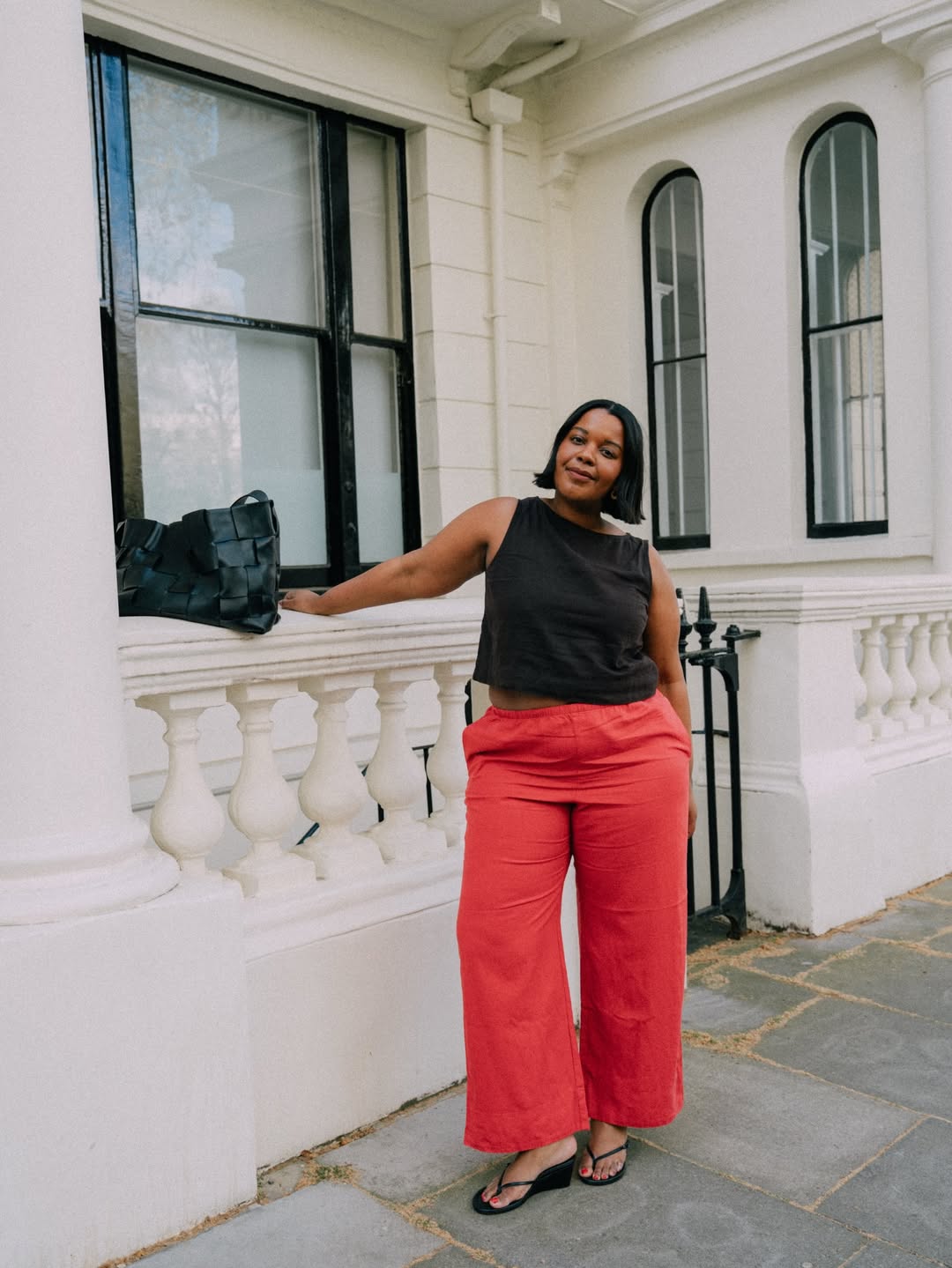 Karina in coral linen trousers