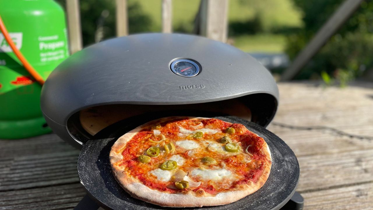 Olive pizza coming out of the Morso Forno Spin