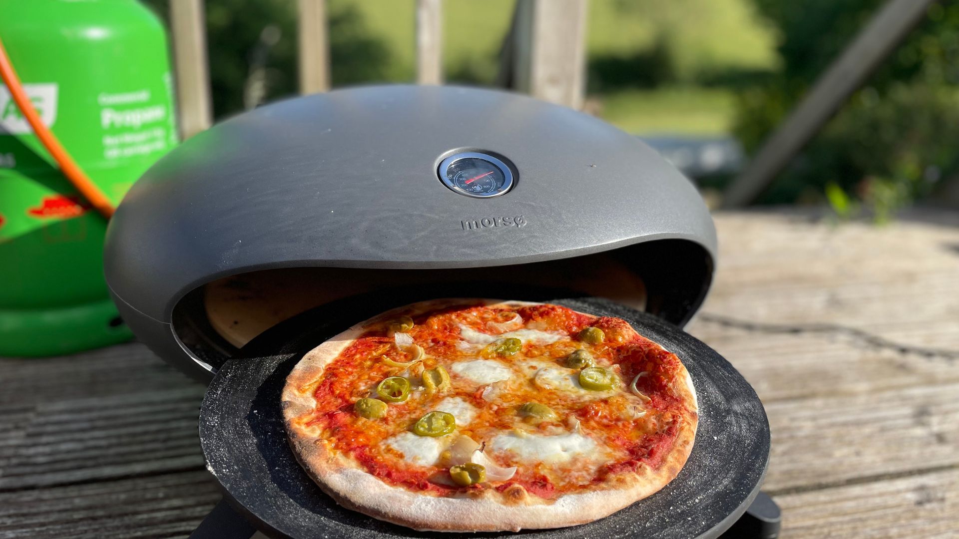 Olive pizza coming out of the Morso Forno Spin