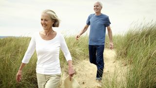 two older walkers at beach