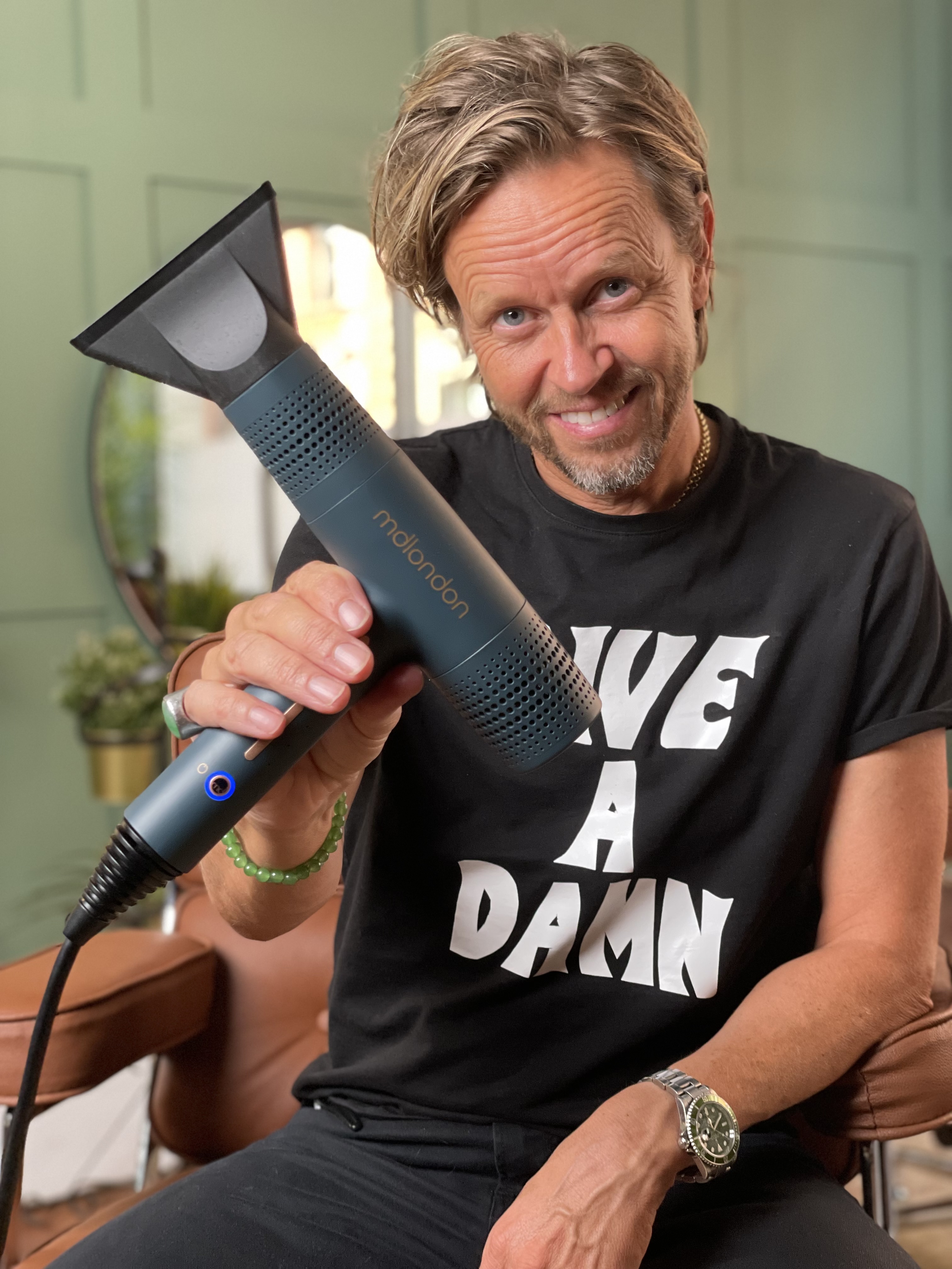 Celebrity stylist Michael Douglas holds his mdlondon BLOW hair dryer