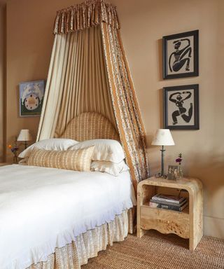 beige color palette bedroom with a floral canopy bed and matching bed skirt and accessories