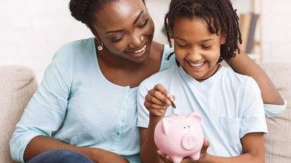 Mother, child and piggy bank