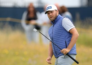 Daniel Brown raises his putter after missing his putt