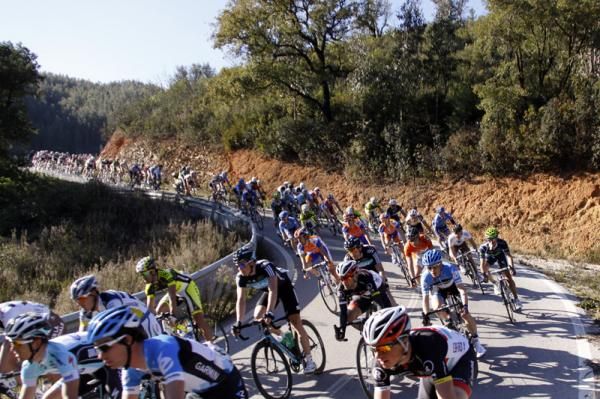 The peloton stretched out on rolling terrain.