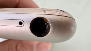 A close up of the headphone port on an original iPhone