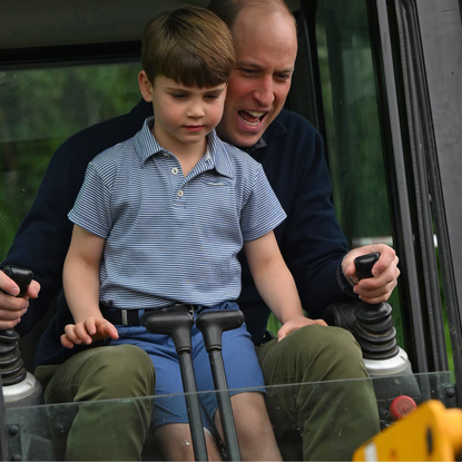 Prince William, Prince of Wales is helped by Prince Louis of Wales