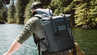 Person using Yeti Hopper M12 backpack cooler