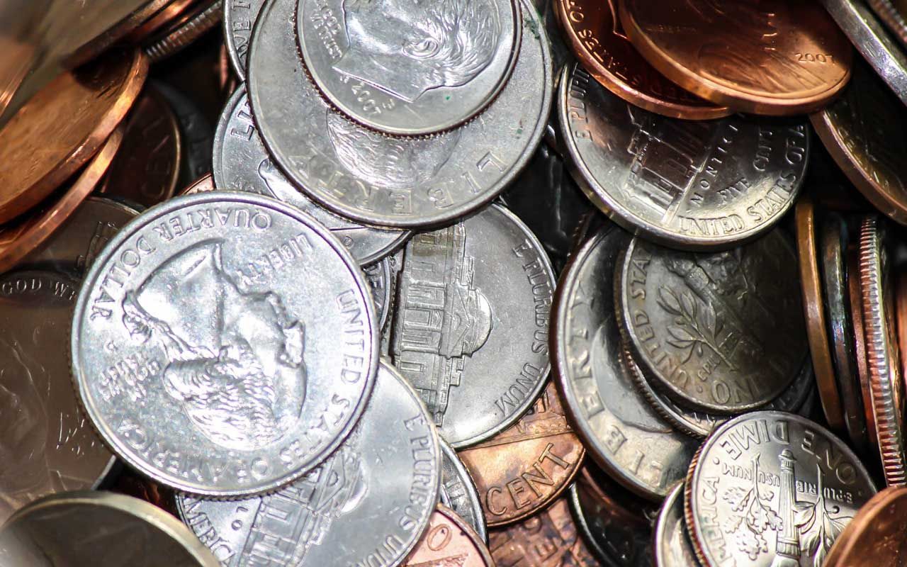 Various assorted american change piling up in jar